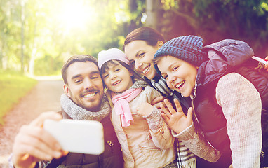 Image showing family with backpacks taking selfie by smartphone