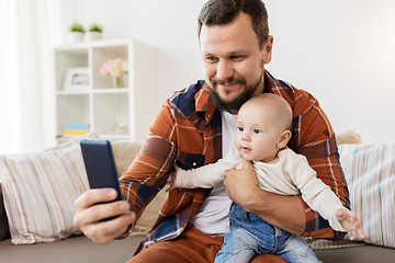 Image showing happy father with baby boy taking selfie at home