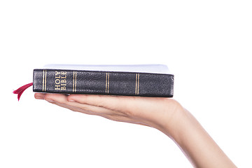 Image showing Woman hand holding the Holy Bible on white background