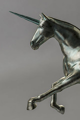 Image showing a beautyful bronze unicorn figure isolated on gray background