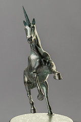 Image showing a beautyful bronze unicorn figure isolated on gray background