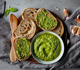 Image showing Bowl of basil pesto on grey table