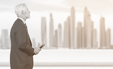 Image showing Senior businessman in front of the big city