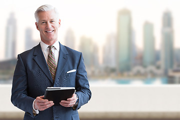 Image showing Senior businessman in front of the big city