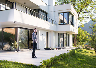 Image showing man in front of his luxury home villa