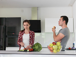 Image showing Young handsome couple in the kitchen