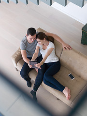 Image showing couple relaxing at  home with tablet computers