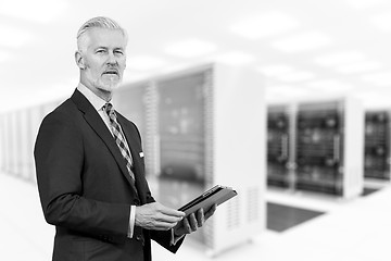 Image showing Senior businessman in server room