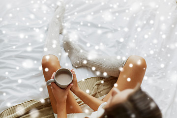 Image showing close up of woman with cocoa cup in bed at home