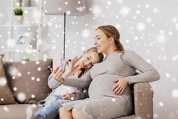 Image showing pregnant woman and girl taking smartphone selfie