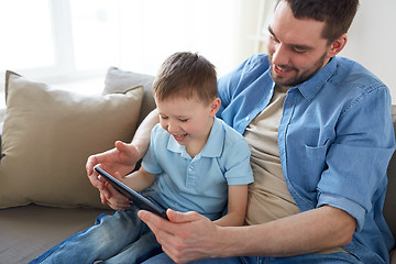 Image showing father and son with tablet pc playing at home