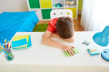 Image showing tired or sad student boy with smartphone at home