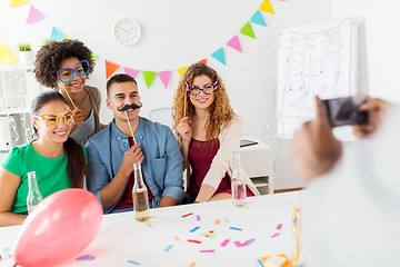 Image showing friends or team photographing at office party