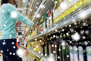 Image showing customer choosing olive oil at supermarket