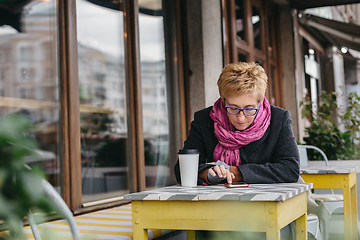 Image showing Woman surfing phone in cafe