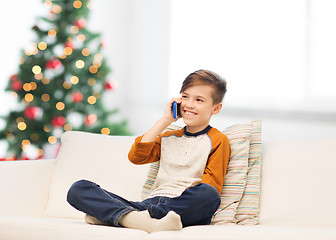 Image showing boy calling on smartphone at home at christmas