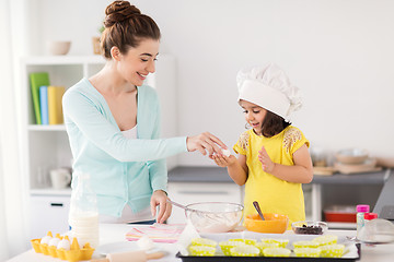 Image showing happy mother and daughter baking at home