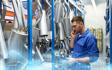 Image showing auto mechanic calling on phone at car shop