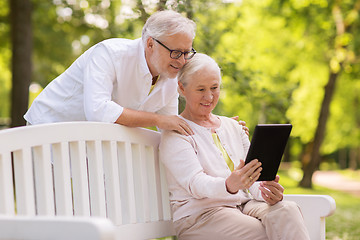 Image showing happy senior couple with tablet pc at summer park