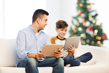 Image showing happy father and son with tablet pc at christmas