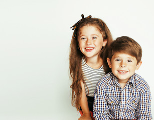 Image showing little cute boy and girl hugging playing on white background