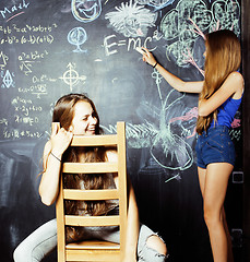 Image showing back to school after summer vacations, two teen girls in classroom with blackboard painted together