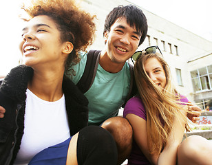 Image showing cute group of teenages at the building of university with books huggings, back to school