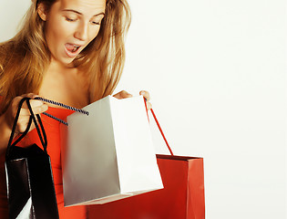 Image showing young pretty blond woman with bags on Christmas sale in red dress isolated white