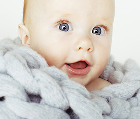 Image showing little cute red head baby in scarf all over him close up isolated