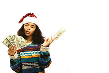 Image showing cute young african girl in santas red hat with money isolated