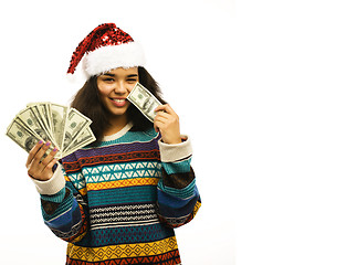 Image showing cute young african girl in santas red hat with money isolated