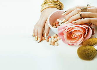 Image showing woman hands with golden manicure  many rings holding brushes, make up artist stuff stylish and pure