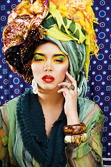 Image showing beauty bright woman with creative make up, many shawls on head like cubian, ethno look closeup