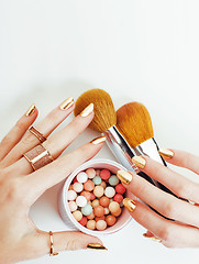 Image showing woman hands with golden manicure  many rings holding brushes, make up artist stuff stylish and pure