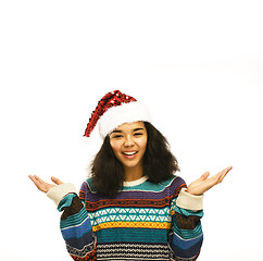 Image showing young pretty african american girl in red christmas hat isolated on white