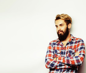 Image showing portrait of young bearded hipster guy smiling on white background