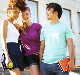 Image showing cute group of teenages at the building of university with books huggings, back to school