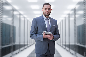 Image showing Young businessman in server room