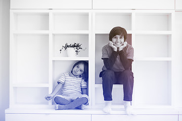 Image showing young boys posing on a shelf