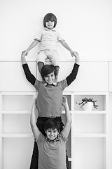 Image showing young boys posing line up piggyback