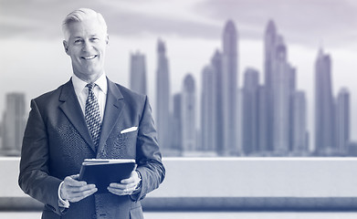 Image showing Senior businessman in front of the big city