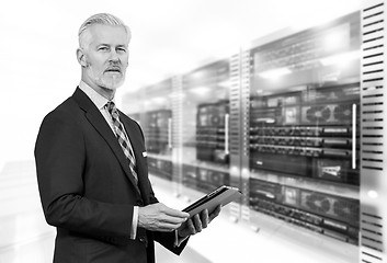 Image showing Senior businessman in server room