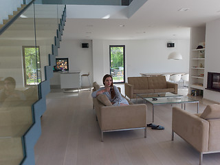 Image showing young woman in a bathrobe enjoying morning coffee