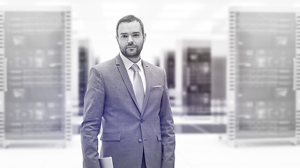 Image showing Young businessman in server room