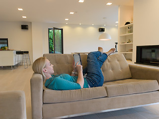 Image showing woman on sofa using tablet computer