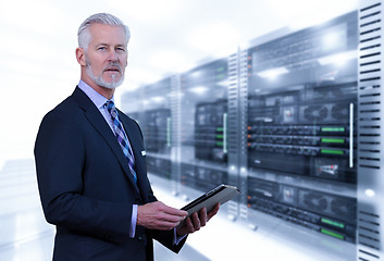 Image showing Senior businessman in server room