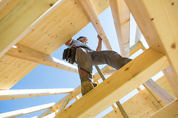 Image showing Builders at work with wooden roof construction.