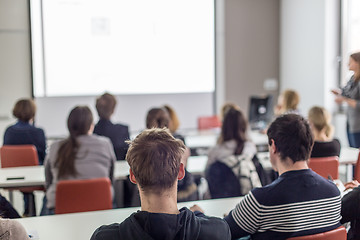 Image showing Woman giving presentation in lecture hall at university.