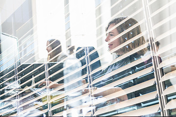 Image showing Yound devoted female software developers team working on desktop computer in IT statup company.