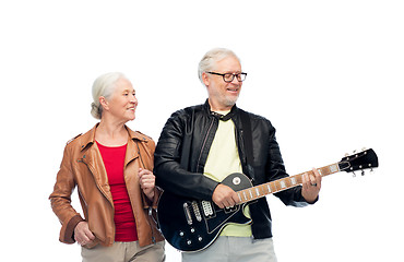 Image showing happy senior couple with electric guitar